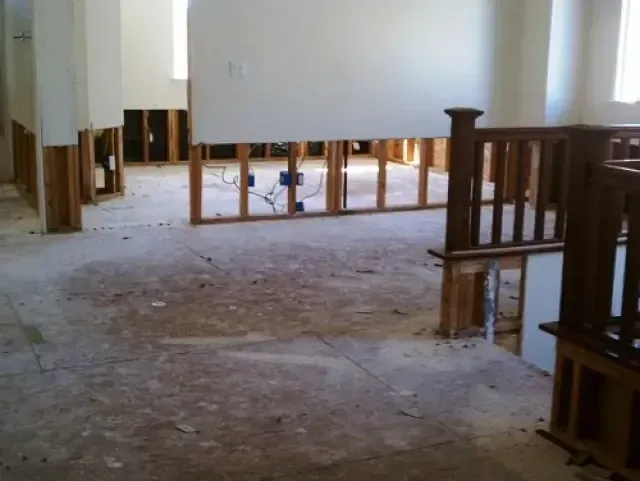 Rooms opened up with the bottom of the drywall cut away during a water damage dry-out