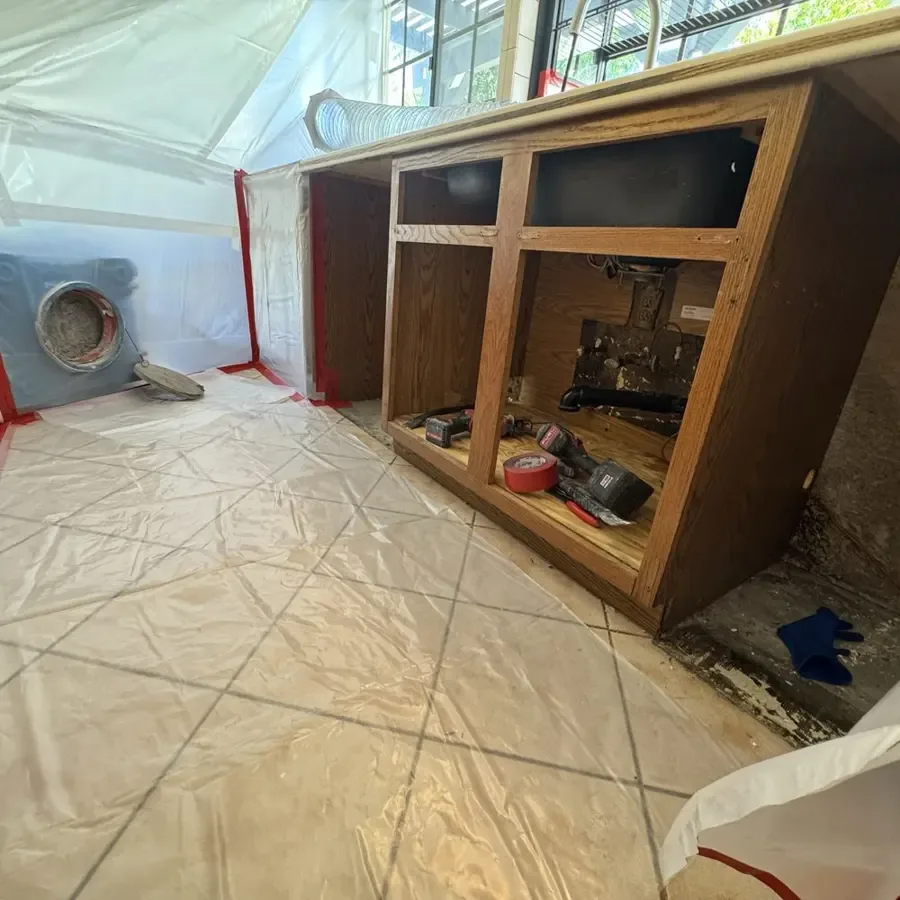Floor damage in a home where a slab leak under the concrete surfaced